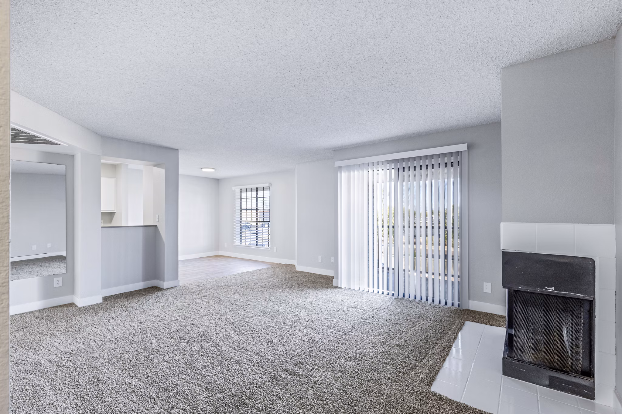 Bright living room with modern decor at Fountain Palms Apartments, featuring a cozy seating area and large windows