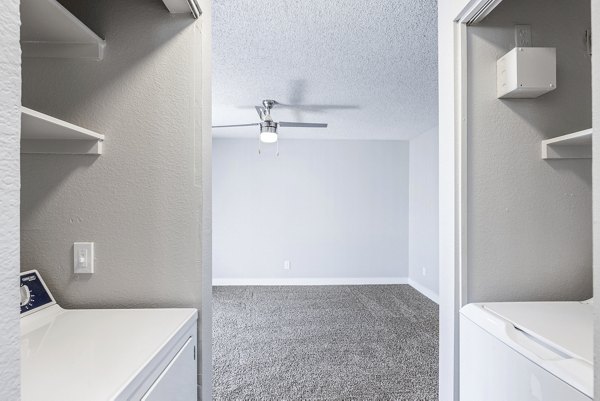 Laundry room with energy-efficient washers and dryers at Fountain Palms Apartments, a luxury Greystar community in Phoenix