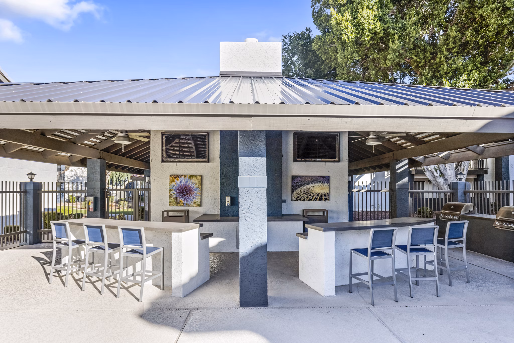 Outdoor patio with grills at Fountain Palms Apartments, offering a relaxing space for residents