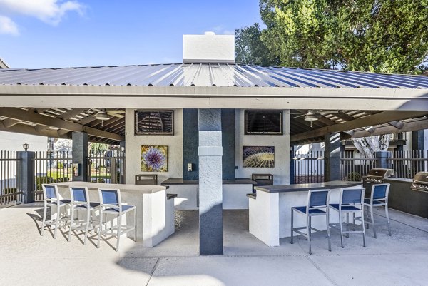 Outdoor patio with grills at Fountain Palms Apartments, offering a relaxing space for residents