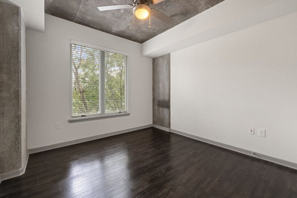 Bedroom featuring contemporary design and cozy furnishings at The Devon Four25 Apartments