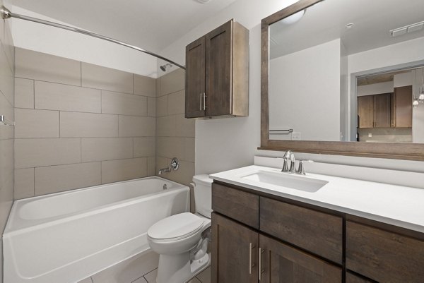 Luxurious bathroom featuring marble countertops at The Devon Four25 Apartments