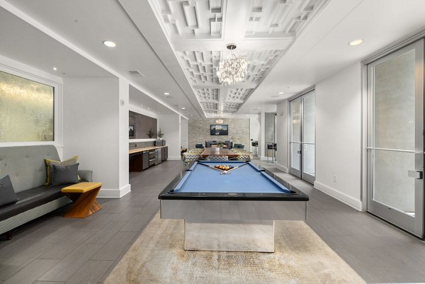 Contemporary game room with billiards and foosball tables at The Devon Four25 Apartments