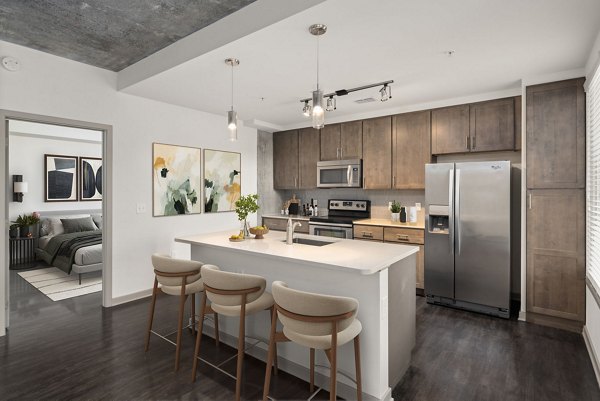 Modern kitchen with sleek countertops and stainless steel appliances at The Devon Four25 Apartments