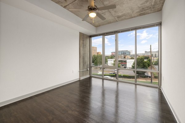 Spacious living room with modern decor in The Devon Four25 Apartments