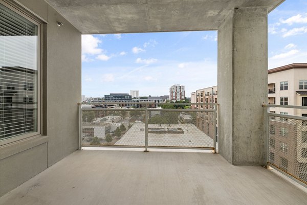 Stylish patio with outdoor seating at The Devon Four25 Apartments, perfect for relaxation and entertainment in vibrant city living