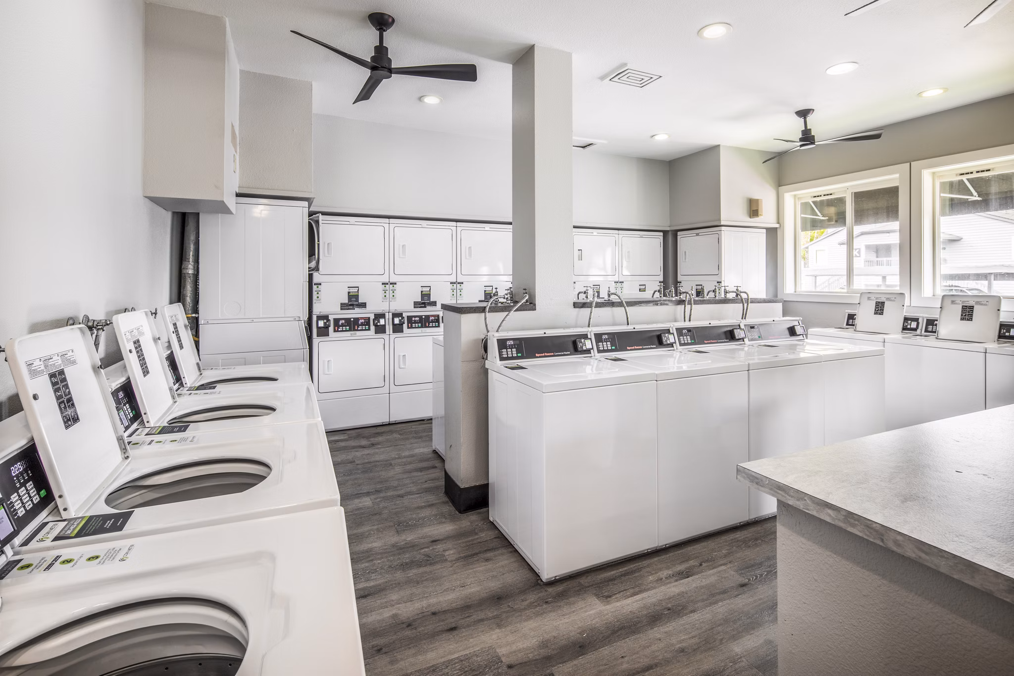 Modern laundry facility at Avana at Happy Valley Apartments, featuring state-of-the-art appliances