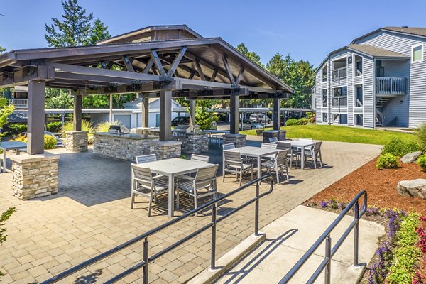 Grill area at Avana at Happy Valley Apartments featuring shaded patio and outdoor seating