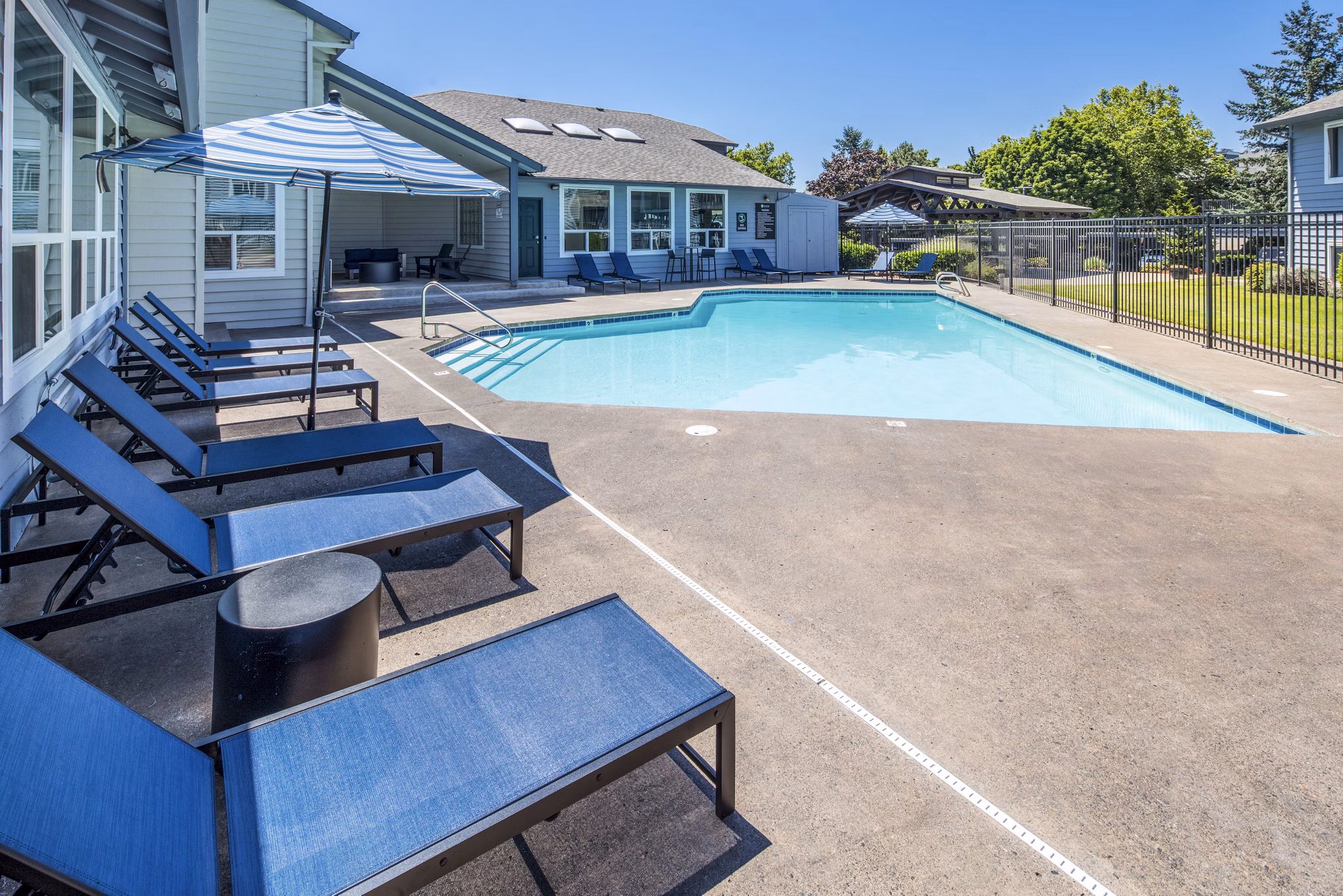 Resort-style pool with lounge chairs at Avana at Happy Valley Apartments