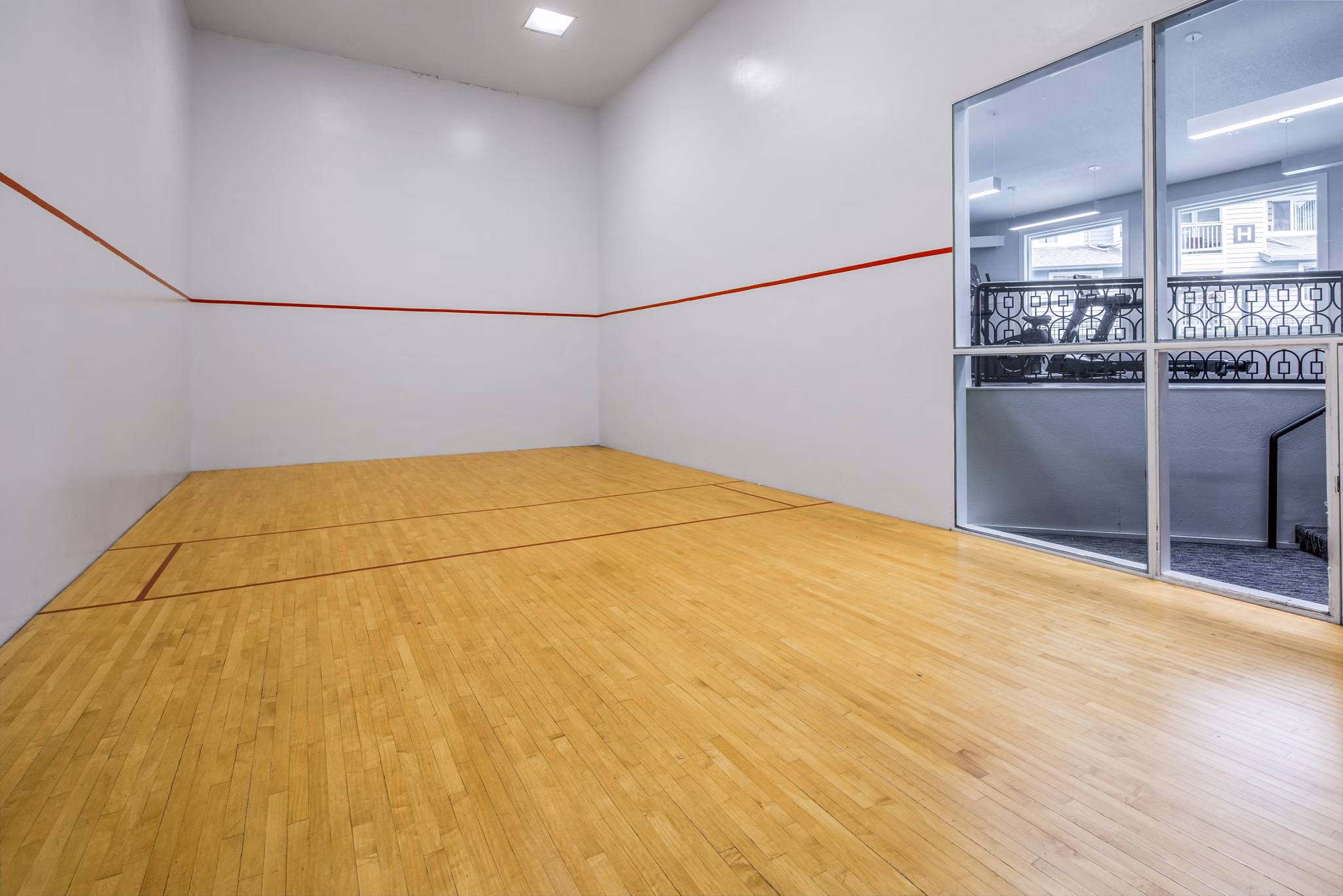 Indoor racquetball court with wooden floors at Avana at Happy Valley Apartments, offering luxury active amenities for residents
