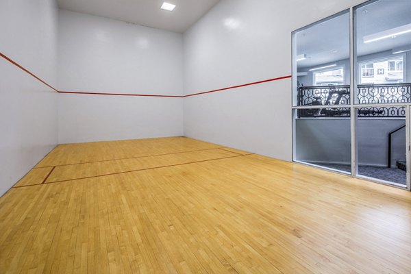 Indoor racquetball court with wooden floors at Avana at Happy Valley Apartments, offering luxury active amenities for residents
