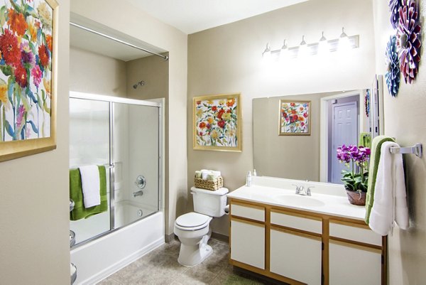 Modern bathroom featuring sleek fixtures and ample counter space in Estancia at City Center Apartments