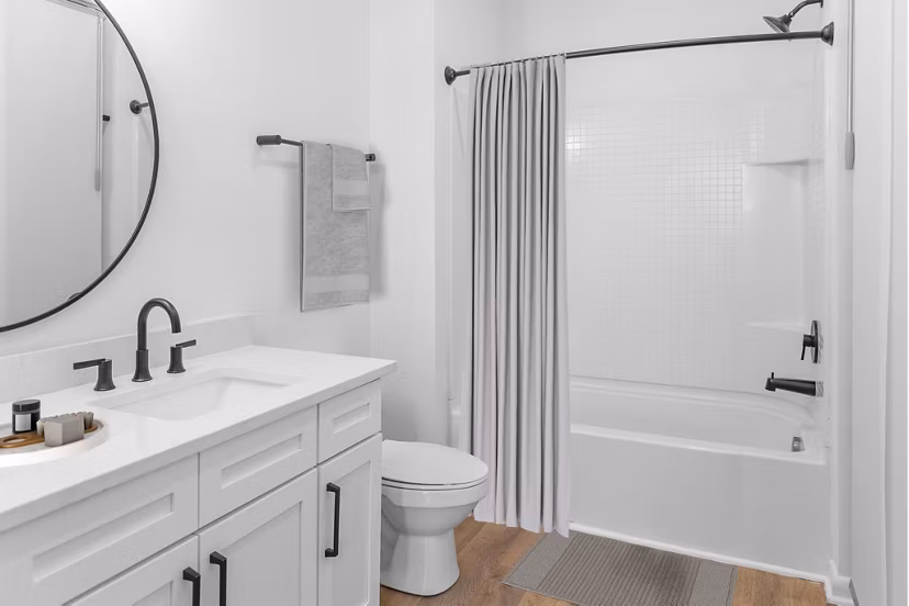 Bathroom featuring sleek fixtures and marble countertops at The Boulevard Apartments