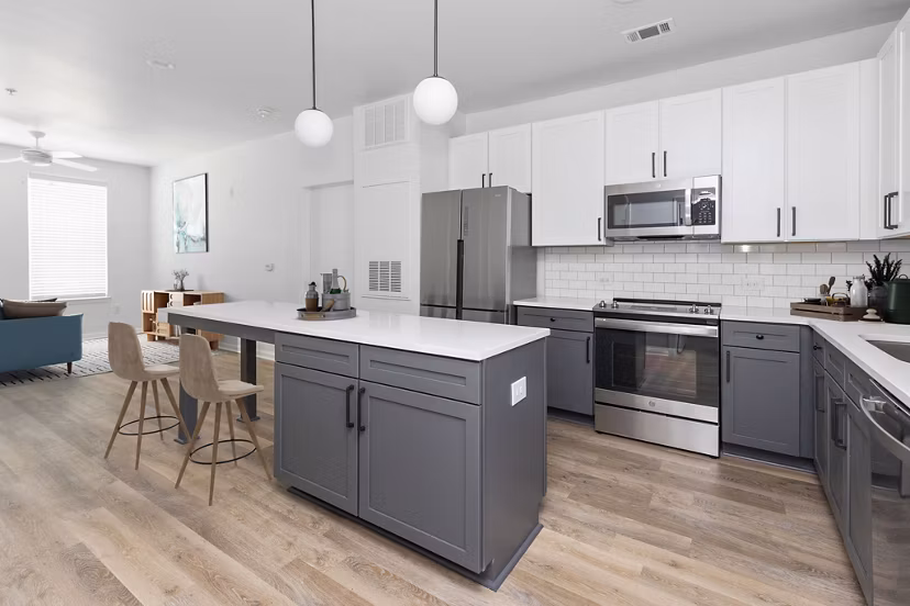 Modern kitchen with stainless steel appliances and island at The Boulevard Apartments