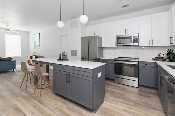 Modern kitchen with stainless steel appliances and island at The Boulevard Apartments