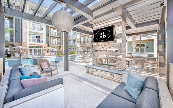 Cozy outdoor patio at The Boulevard Apartments featuring modern seating and lush greenery