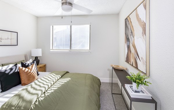 Cozy bedroom with modern furnishings at Terra Vista at the Park Apartments
