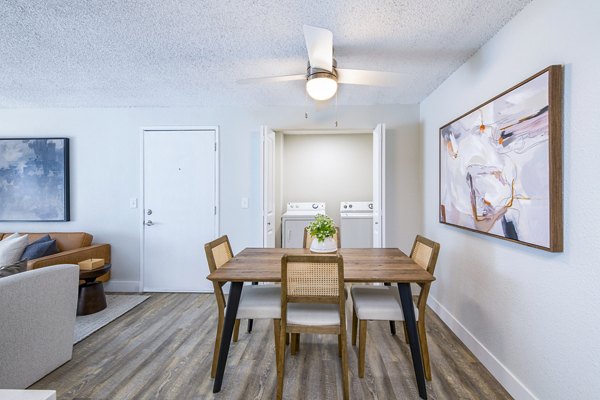 Dining area and in-unit laundry at Terra Vista at the Park Apartments, offering modern conveniences and stylish interiors for a comfortable living experience
