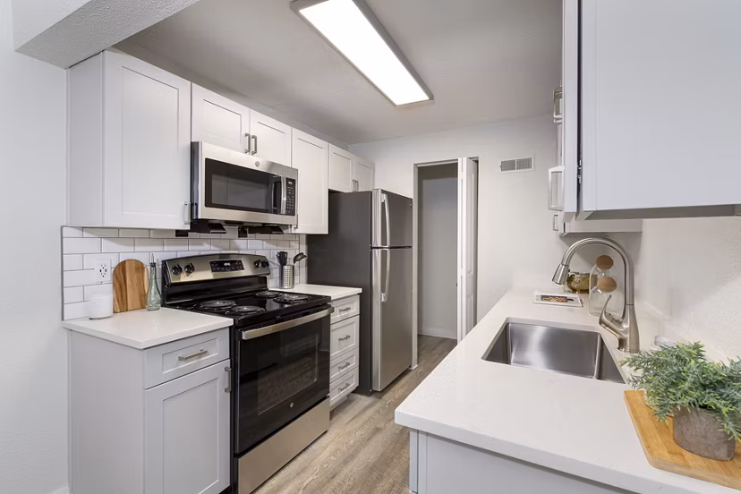 Modern kitchen featuring stainless steel appliances and granite countertops at Terra Vista at the Park Apartments