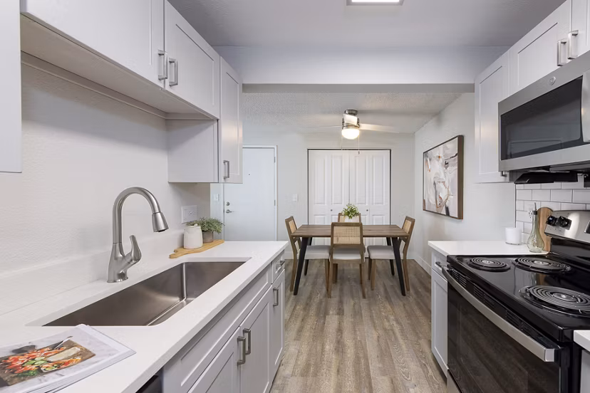 Modern kitchen with sleek countertops and stainless steel appliances at Terra Vista at the Park Apartments