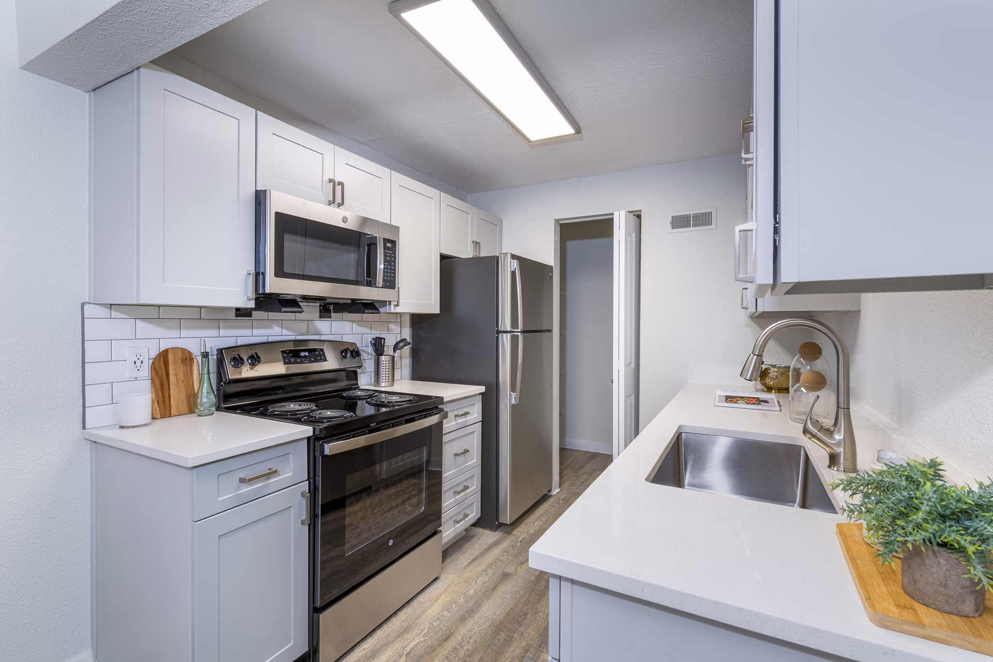 Modern kitchen with stainless steel appliances and granite countertops in Terra Vista at the Park Apartments