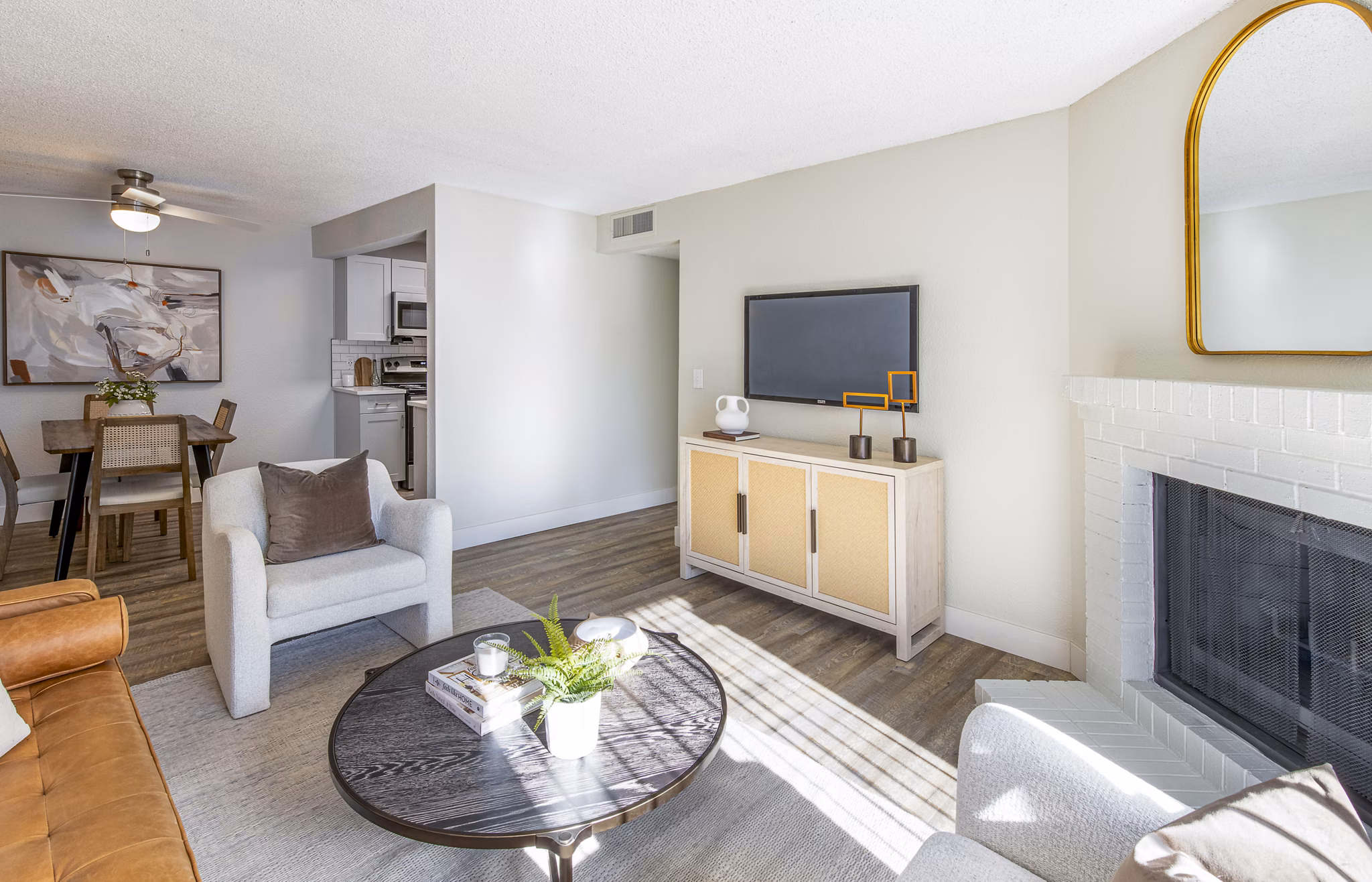 Cozy living room with natural light and stylish furniture at Terra Vista at the Park Apartments, offering comfortable living spaces