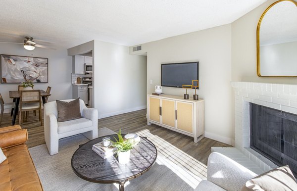 Cozy living room with natural light and stylish furniture at Terra Vista at the Park Apartments, offering comfortable living spaces