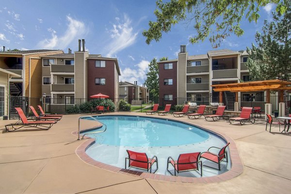 Relaxing pool area with palm trees at Terra Vista at the Park Apartments