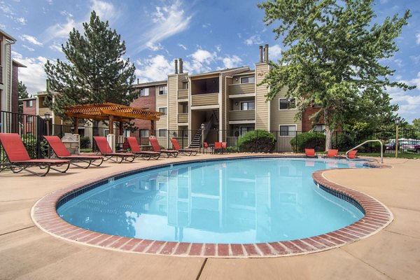Luxurious pool area at Terra Vista at the Park Apartments featuring sun loungers and landscaped gardens