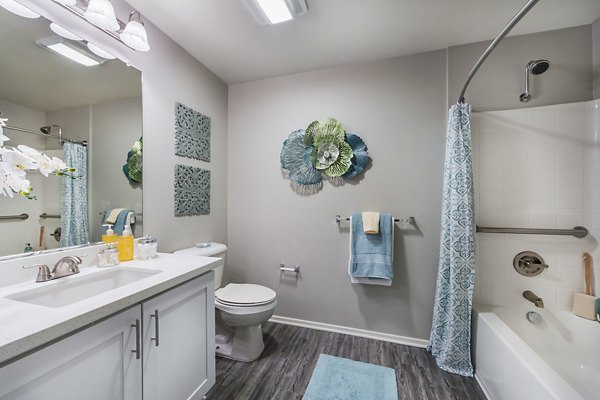 Bathroom featuring modern fixtures and double vanity at Overture Riverwalk luxury apartments