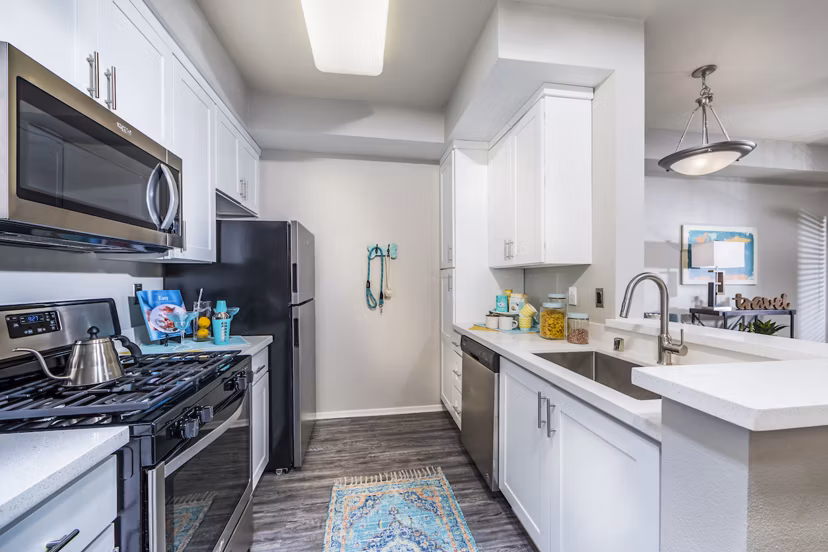 Modern kitchen with sleek countertops and stainless steel appliances at Overture Riverwalk luxury apartments