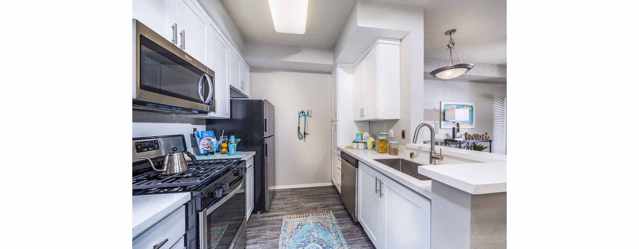 Modern kitchen with sleek countertops and stainless steel appliances at Overture Riverwalk luxury apartments