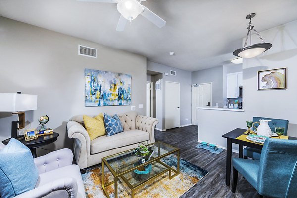 Elegant living room with modern decor and large windows in Overture Riverwalk luxury apartments