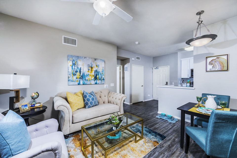 Elegant living room with modern decor and large windows in Overture Riverwalk luxury apartments