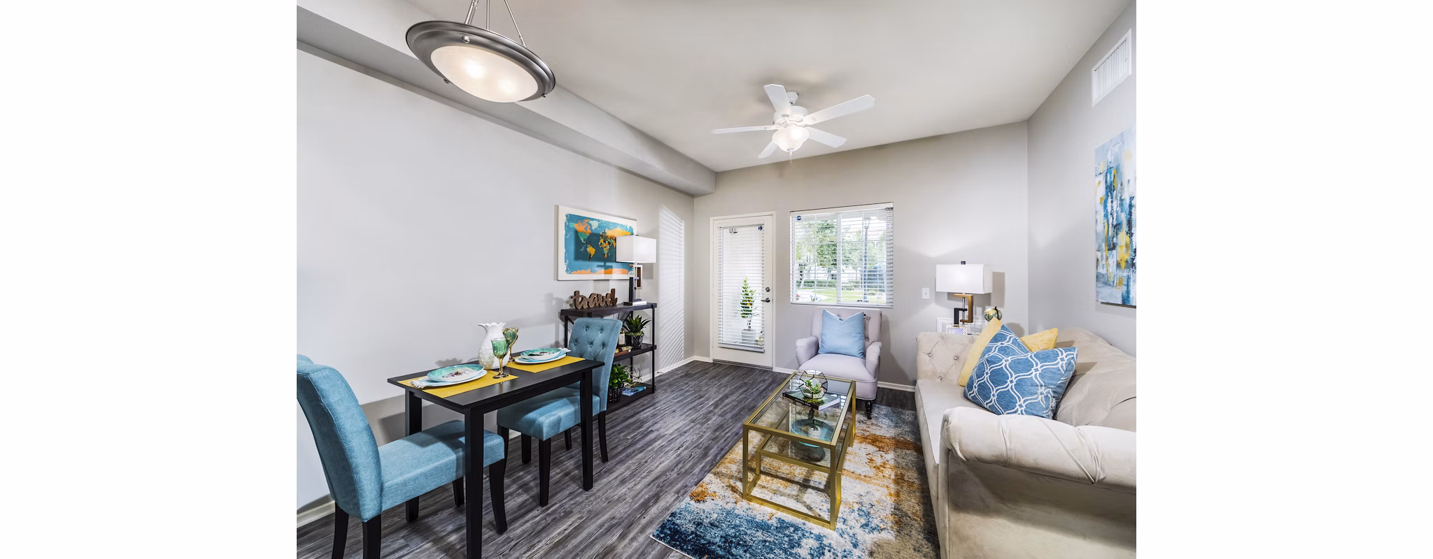 Spacious living room with modern furnishings and large windows in Overture Riverwalk luxury apartments