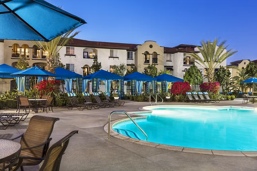 Resort-style pool with lounge seating at Overture Riverwalk luxury apartments