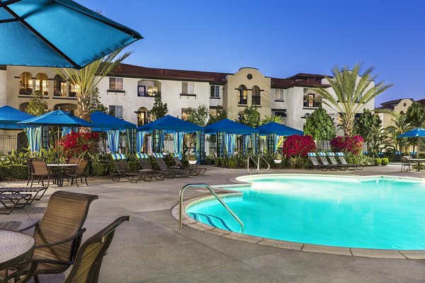 Resort-style pool with lounge seating at Overture Riverwalk luxury apartments