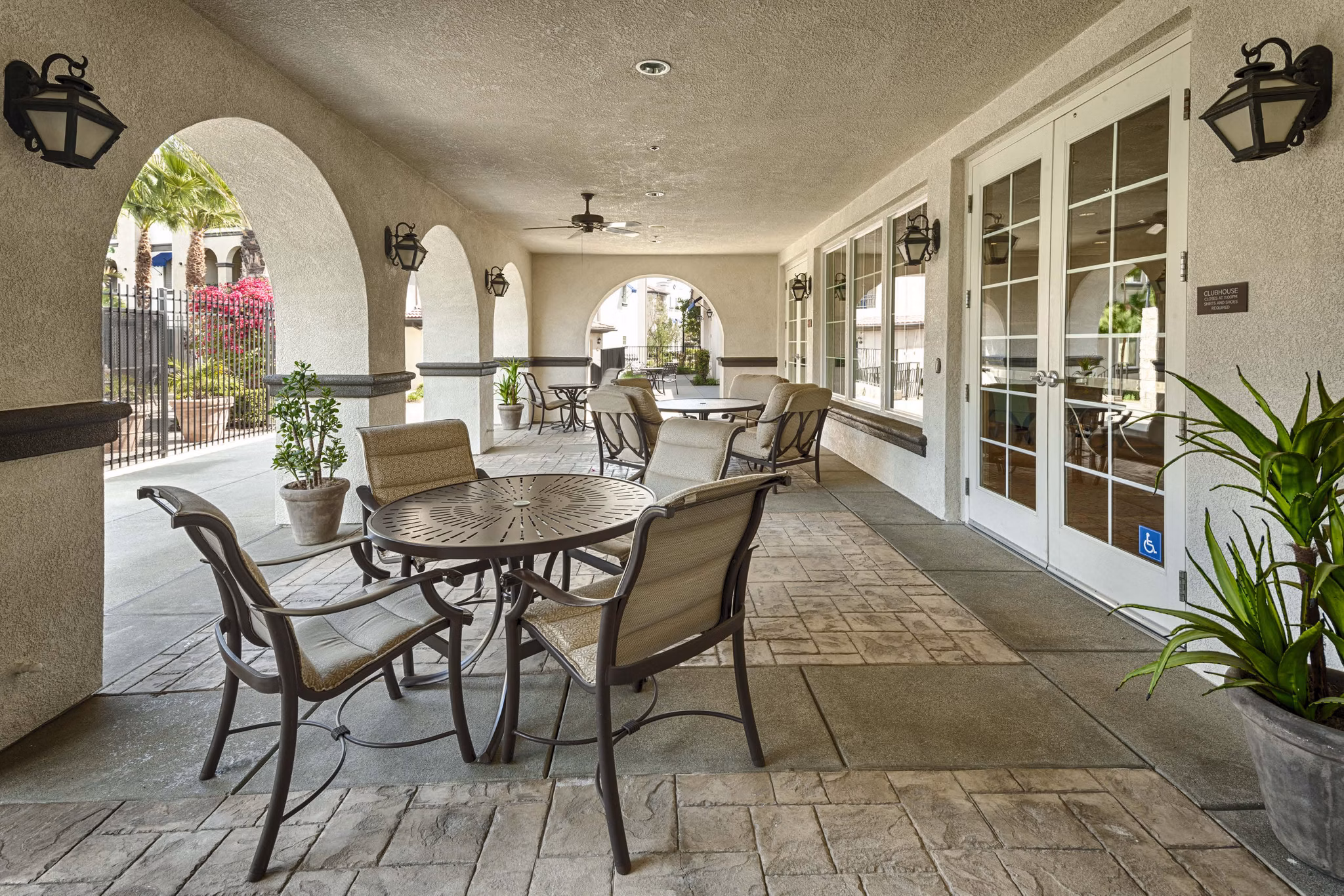 Patio area with comfortable seating and lush greenery at Overture Riverwalk Apartments