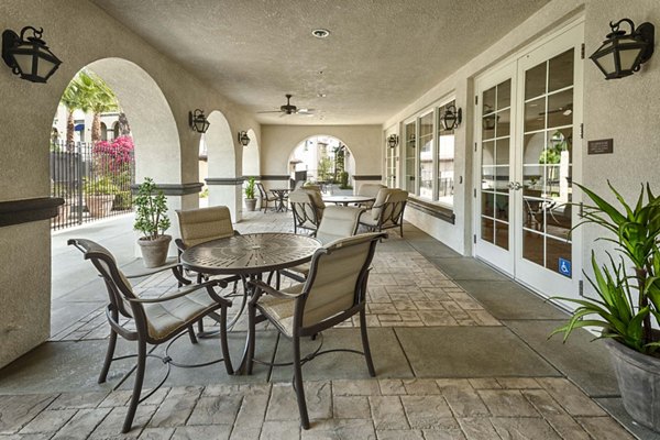 Patio area with comfortable seating and lush greenery at Overture Riverwalk Apartments