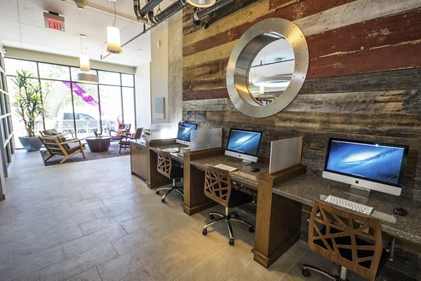 Business center with modern workstations at Corazon Apartments in Greystar's luxury apartment community