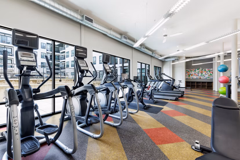 Modern fitness center with state-of-the-art equipment at Corazon Apartments