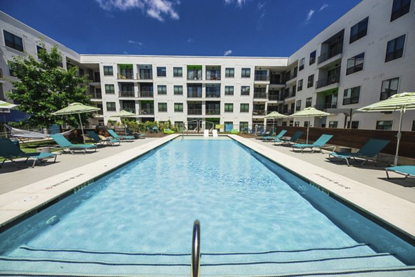 Rooftop pool with lounge chairs at Corazon Apartments offering luxury living