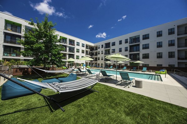 Relaxing pool area with sun loungers at Corazon Apartments, a Greystar luxury community