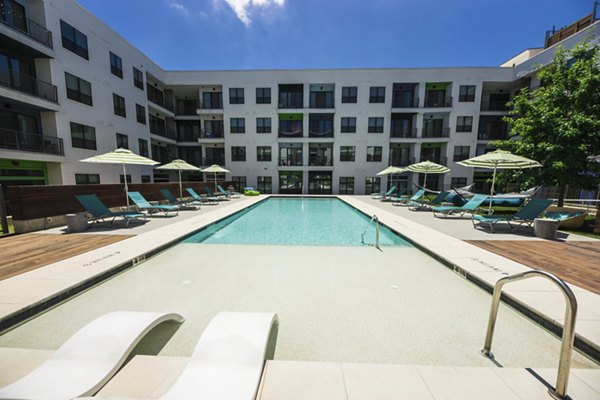 Outdoor pool with sleek lounge chairs at Corazon Apartments, a luxury property by Greystar Enjoy leisure and relaxation in this modern setting