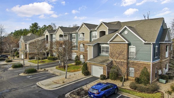 Luxury apartment complex with multiple buildings and parking spaces in a vibrant community