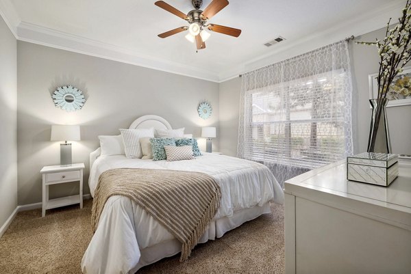 Bedroom featuring modern decor and large windows at Braxton at Brier Creek Apartments