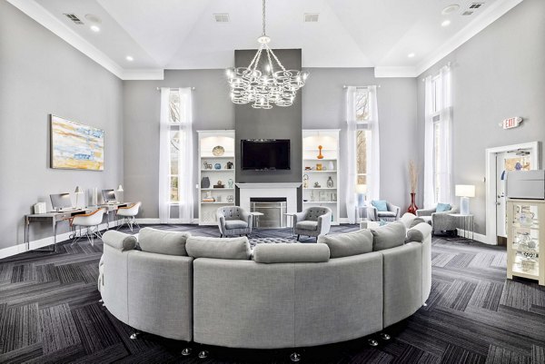 Clubhouse at Braxton at Brier Creek Apartments: Modern social space with plush seating and billiards table
