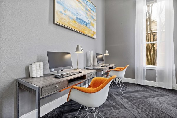 Modern business center with workstations at Braxton at Brier Creek Apartments, ideal for remote work and collaboration