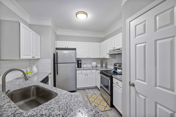 Modern kitchen with stainless steel appliances at Braxton at Brier Creek Apartments, offering luxury living in a stylish setting