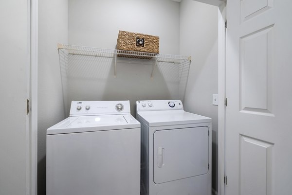 Well-appointed laundry room with modern appliances in Braxton at Brier Creek Apartments